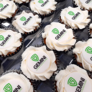 Frosted branded cupcakes in black cases
